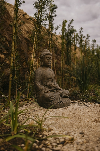Estátua de Buda no jardim zen, simbolizando a paz, equilíbrio e tranquilidade do nosso refúgio